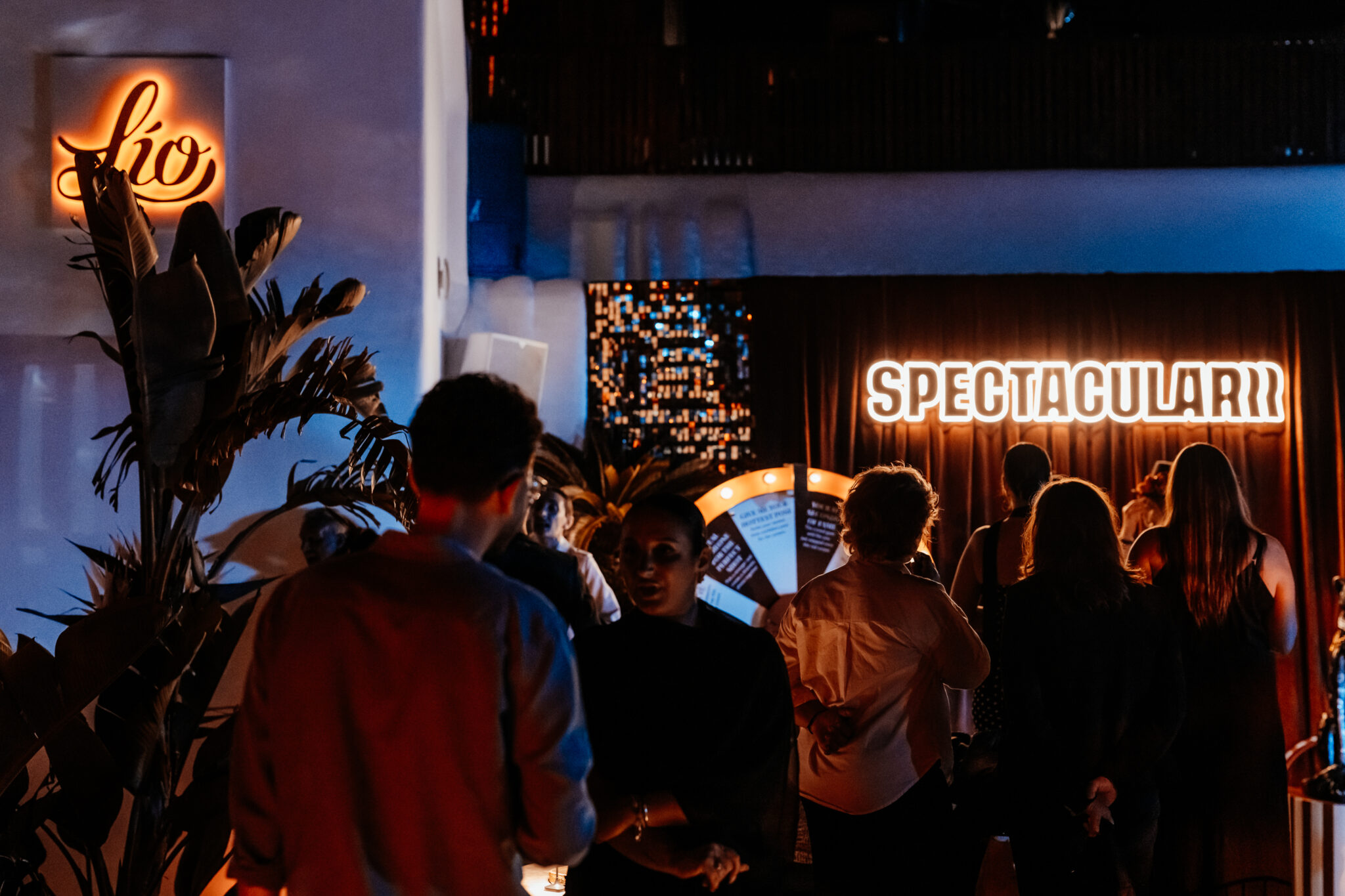 Lío Mykonos: One Last Spectacularrr Night. Guests arriving beneath the illuminated Spectacularrr sign at Lío Mykonos.