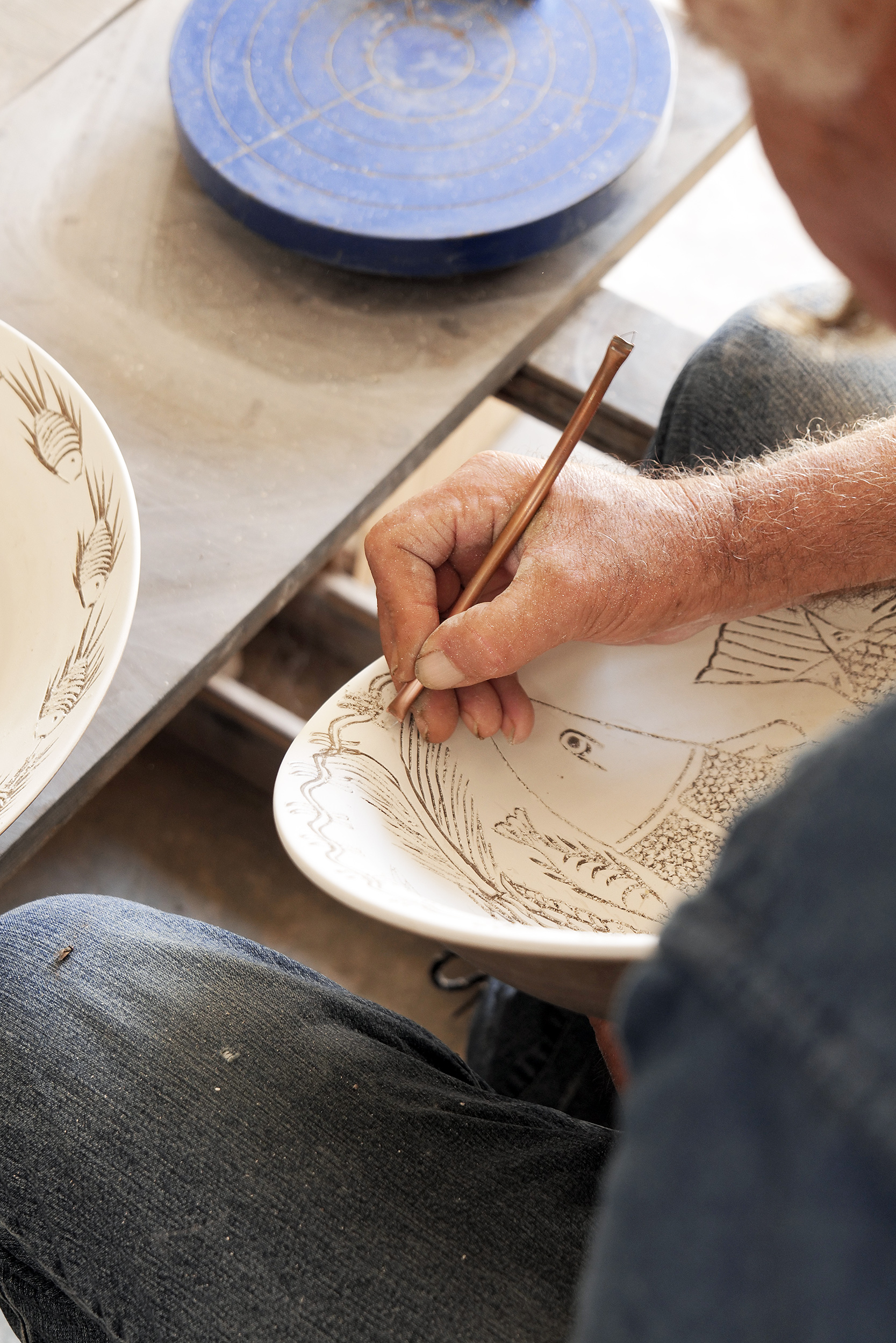 Inside the Pottery Workshops of Sifnos: fine decoration on a plate at the Lebesis workshop