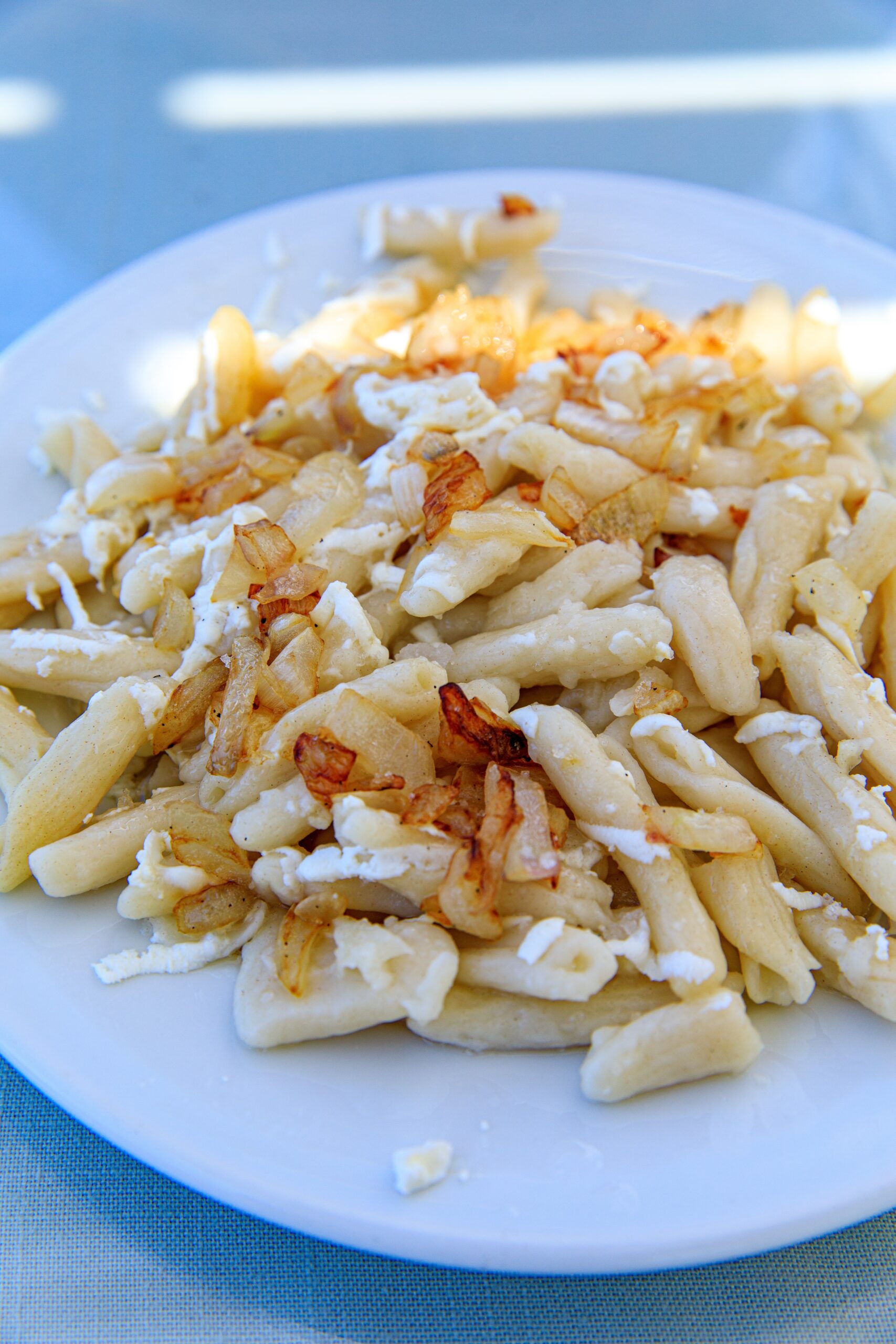 Cheeses of the South Aegean: Makarounes pasta topped with cheese and fried onions