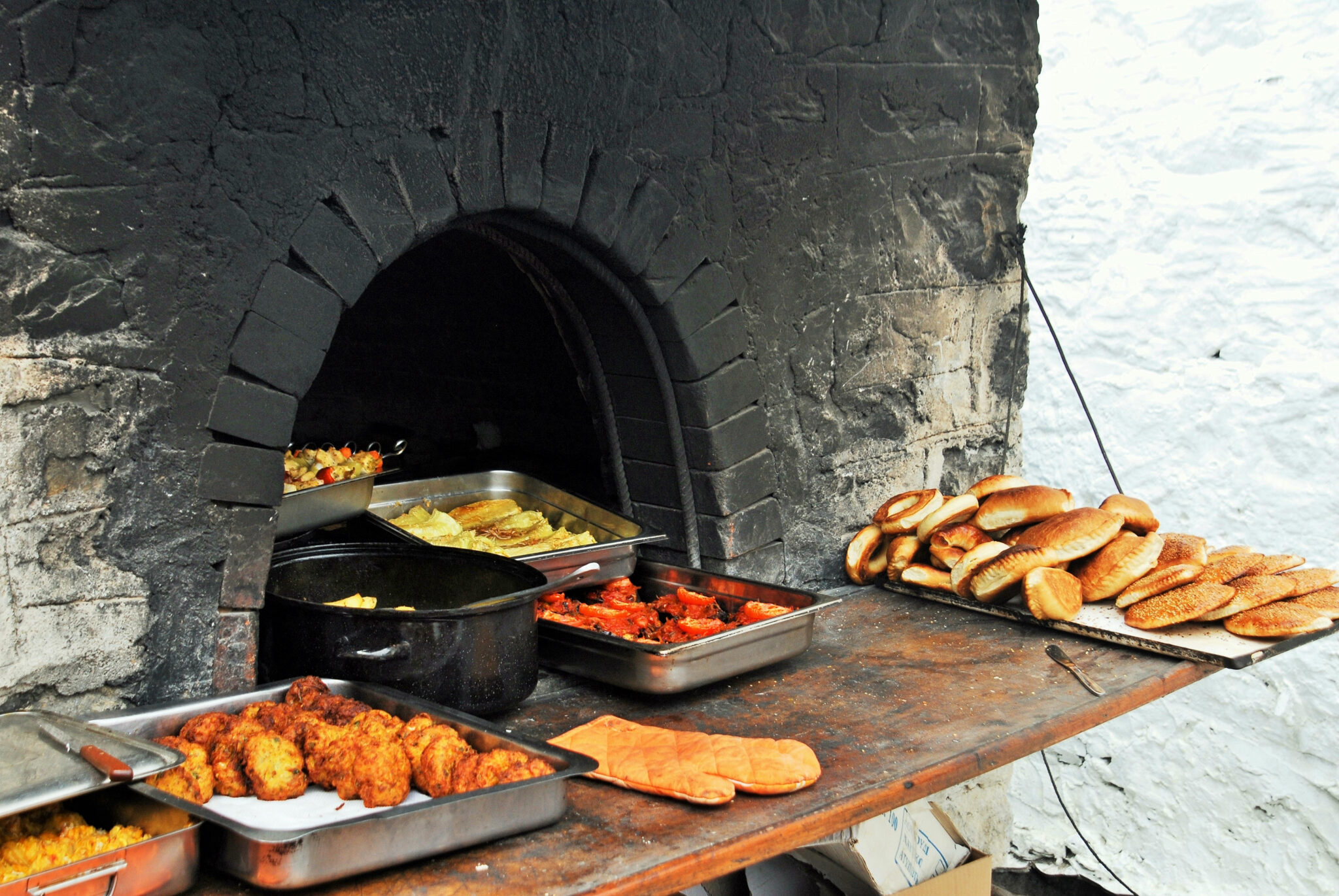 Cheeses of the South Aegean: Bread and baked dishes beside a stone oven on Karpathos