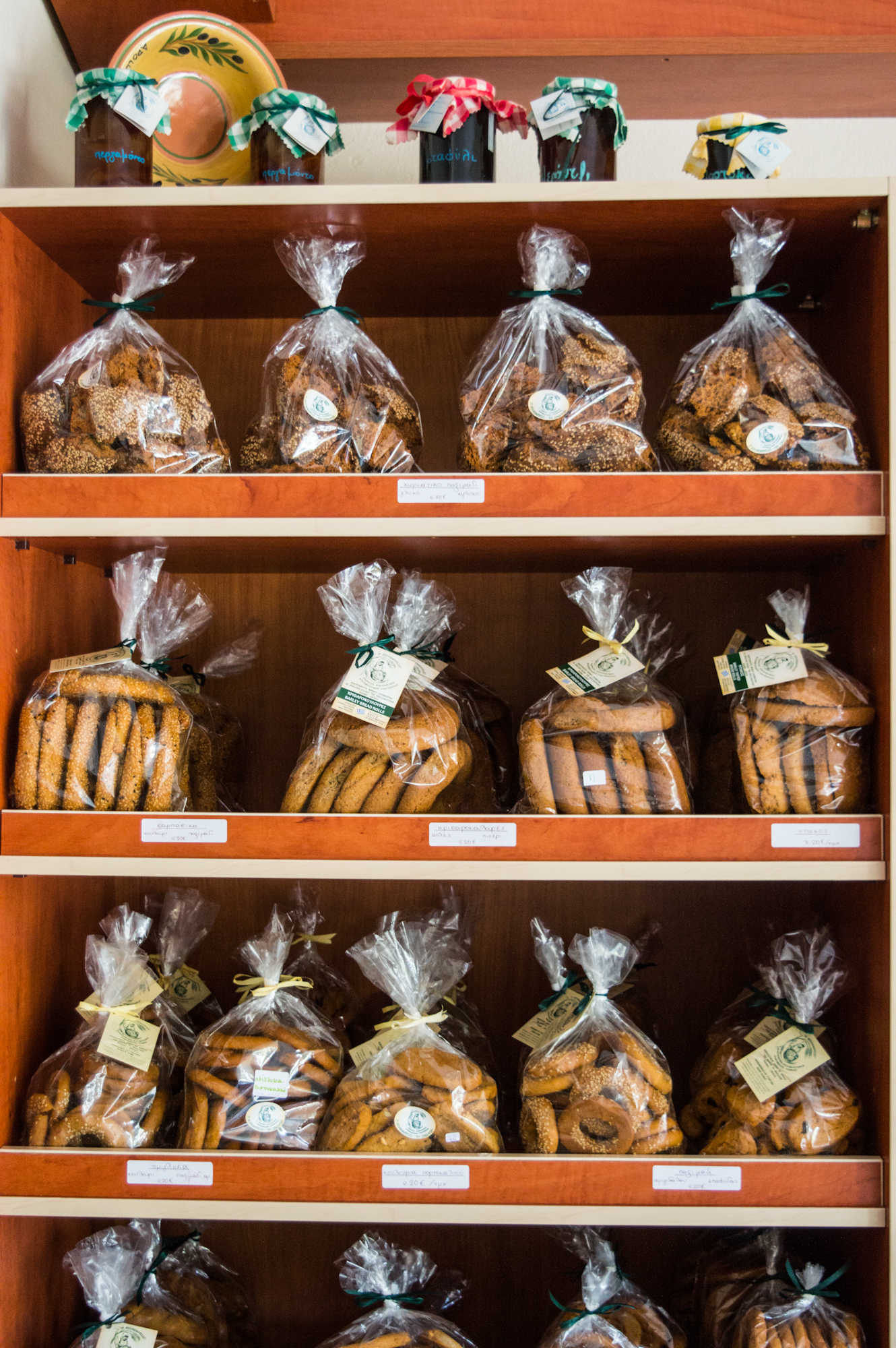 Cheeses of the South Aegean: Traditional baked goods displayed on shelves in Rhodes