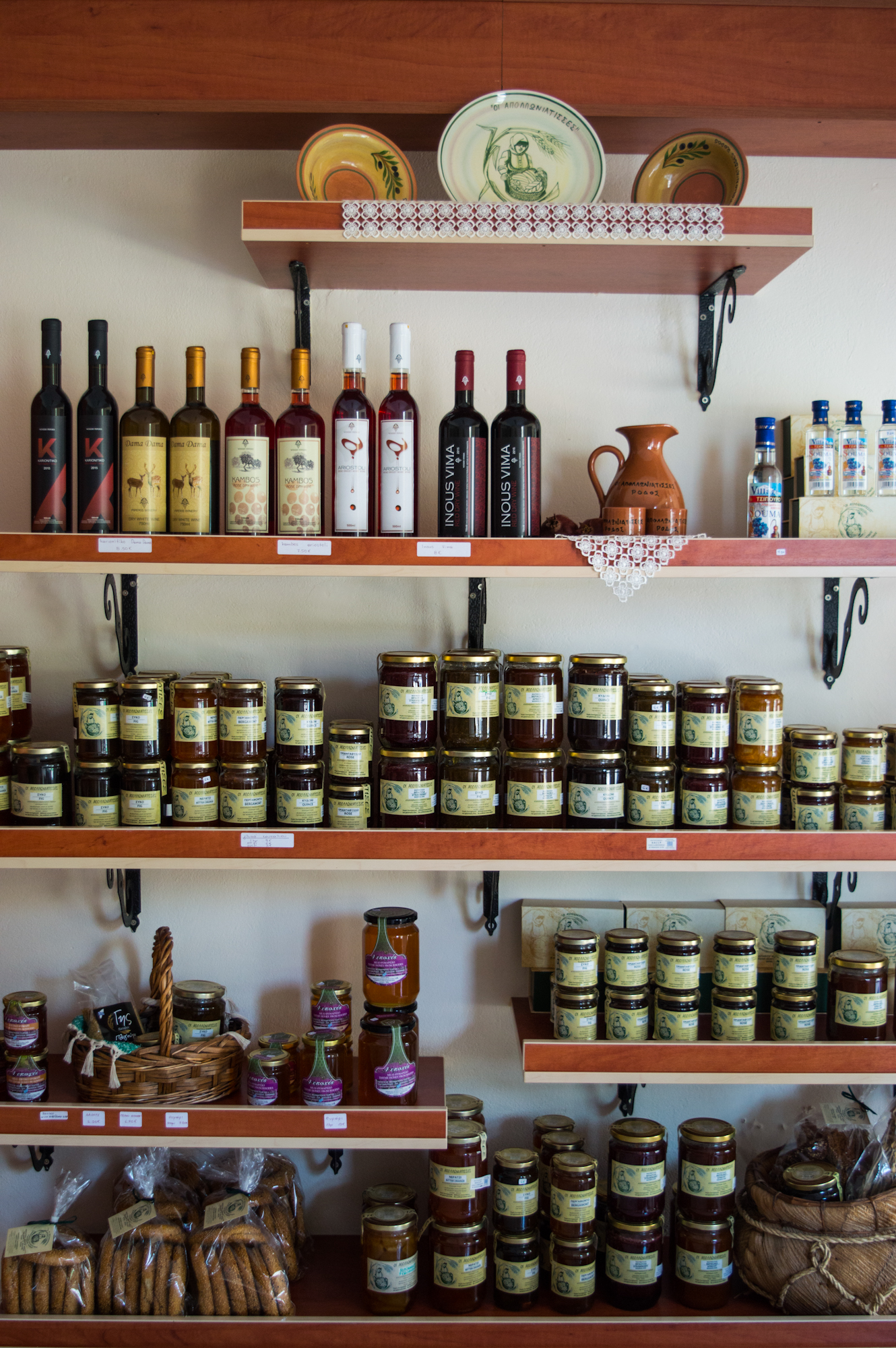 Cheeses of the South Aegean: Local wines and jars of preserves on shop shelves in Rhodes